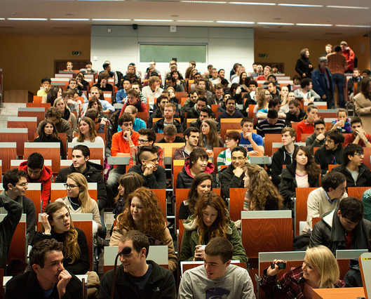 College students gathered in a tiered lecture hall.