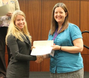 Rebekah receiving the Outstanding Presentation Award from Dr. Sutherlin